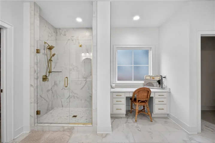 Luxurious bathroom retreat with a spacious walk-in shower and elegant tile flooring.