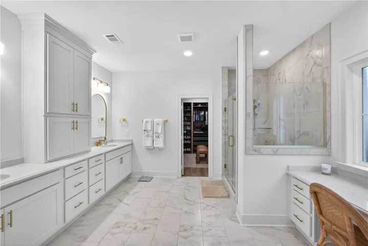 Luxurious bathroom retreat with dual vanities and a spacious walk-in shower.