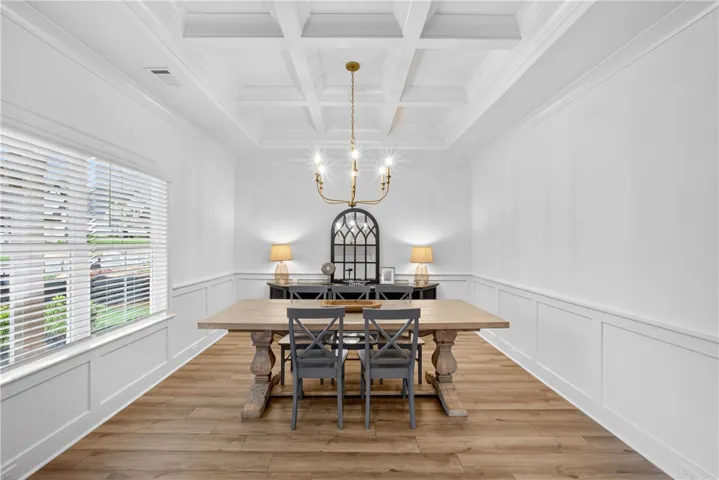 Elegant coffered ceilings and wainscoting define this refined dining area.