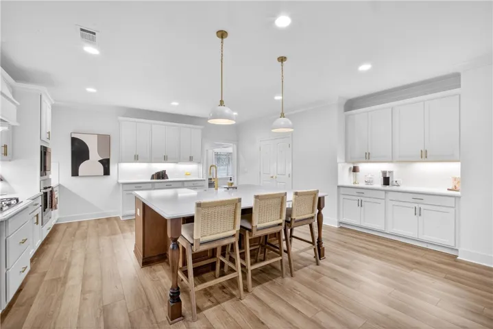 A pristine culinary space with an island, perfect for entertaining.