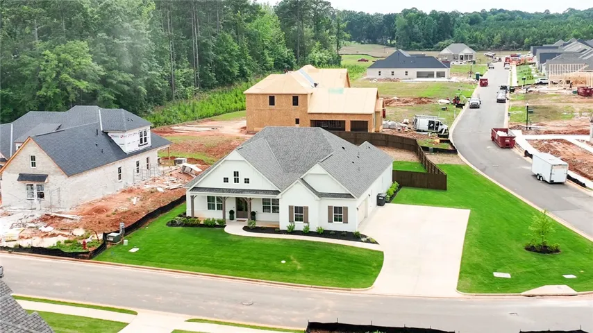 Corner lot with extended concrete driveway.