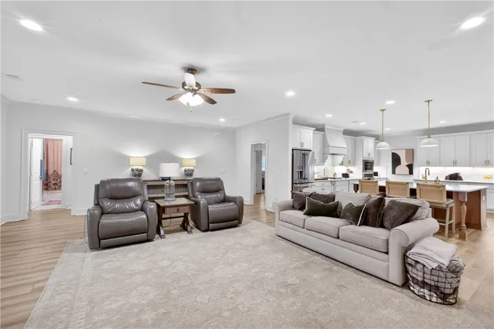 An inviting open-concept living space seamlessly merges with a modern, well-appointed kitchen.