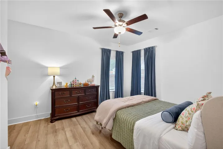Light LVP floors and bright windows illuminate this spacious and comfortable sleeping quarter.