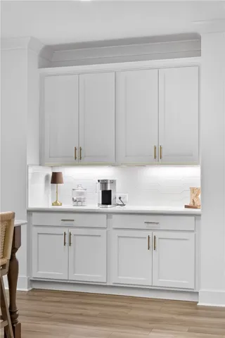 A well-appointed coffee bar with a stylish backsplash, offering convenient refreshment.