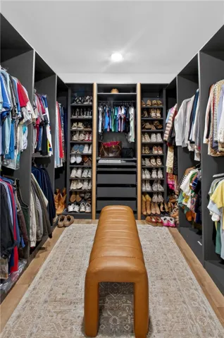 Ample storage solutions and elegant LVP flooring define this organized closet.