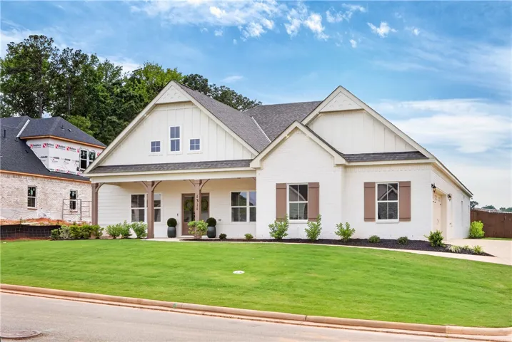 A striking home and an inviting covered entry, poised against a brilliant blue sky.