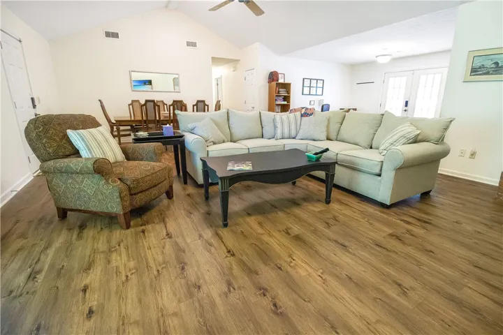 An inviting gathering space features an open floorplan and resilient flooring under soaring vaulted ceilings.