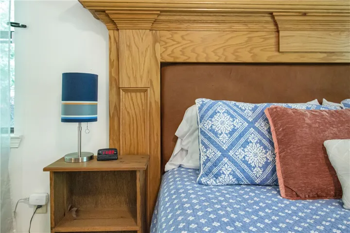 A crafted wood headboard adds a classic touch to this comfortable bedroom.