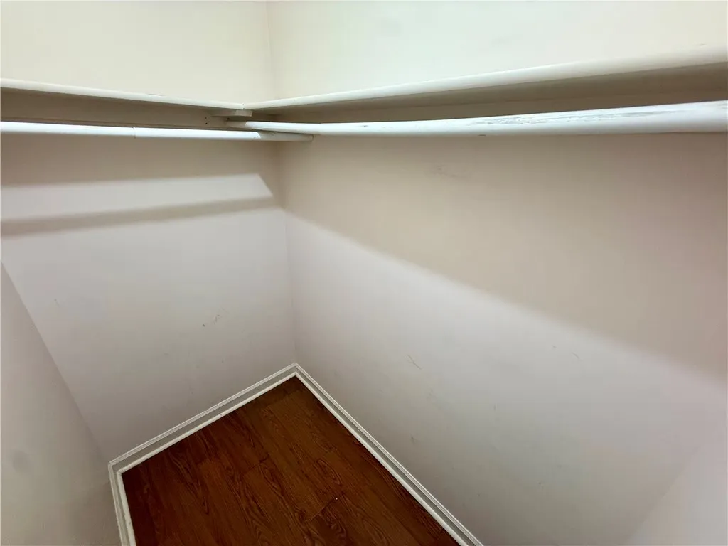Ample storage space is offered in this well-appointed closet with durable flooring.