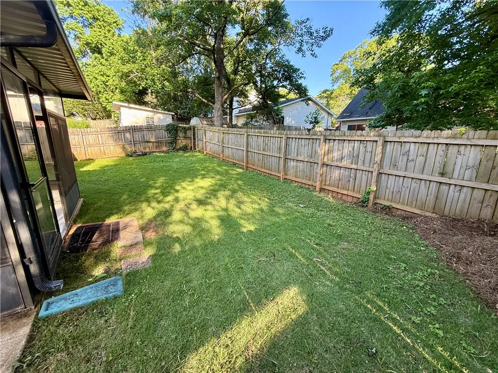 A fully fenced backyard offers a private green oasis for outdoor enjoyment.