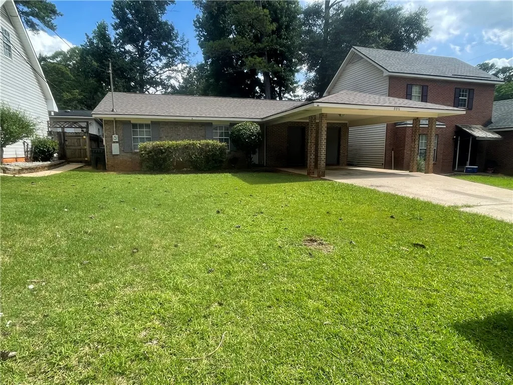 A well-maintained lawn welcomes you to this charming brick home featuring a convenient carport.