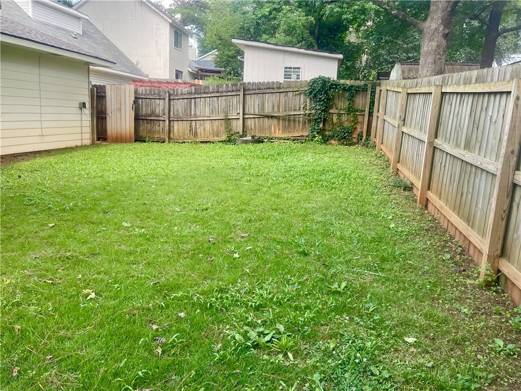 A well-maintained fenced yard offers private green space for outdoor activities.