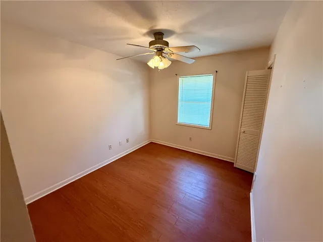 Hardwood floors and a well-lit window create a comfortable and inviting atmosphere in this room.