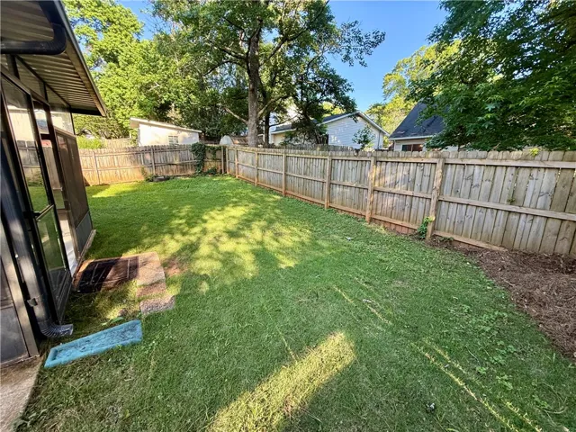 A fully fenced backyard offers a private green oasis for outdoor enjoyment.