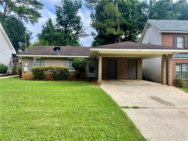 A classic brick facade welcomes you to this charming residence, complete with a convenient covered carport and mature landscaping.