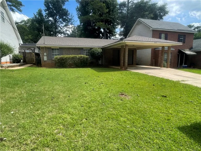 A well-maintained lawn welcomes you to this charming brick home featuring a convenient carport.
