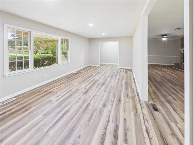 A well-lit interior space with fresh flooring invites comfortable living.
