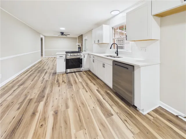 A well-appointed kitchen showcasing contemporary appliances and sleek, durable flooring.