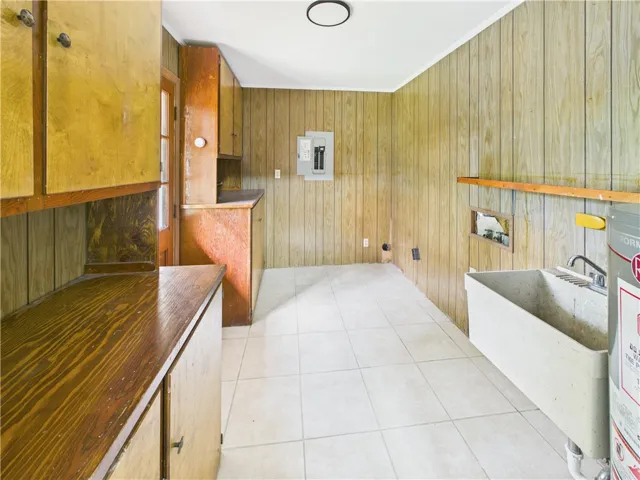 Functional utility space with durable wood-paneled walls and easy-to-clean tiled floors.