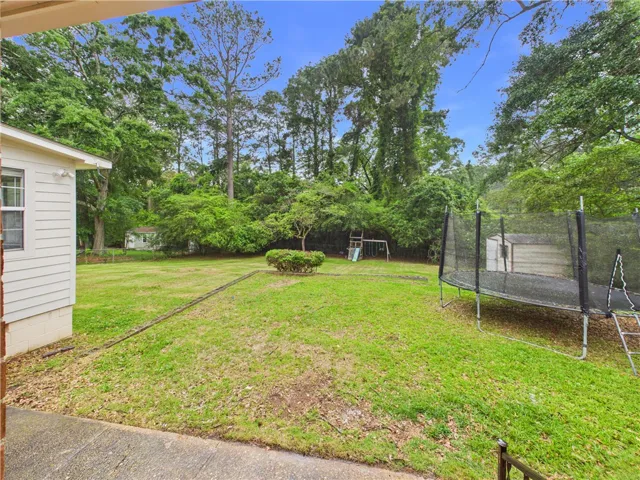 A lush green yard provides ample space for recreation and outdoor enjoyment.