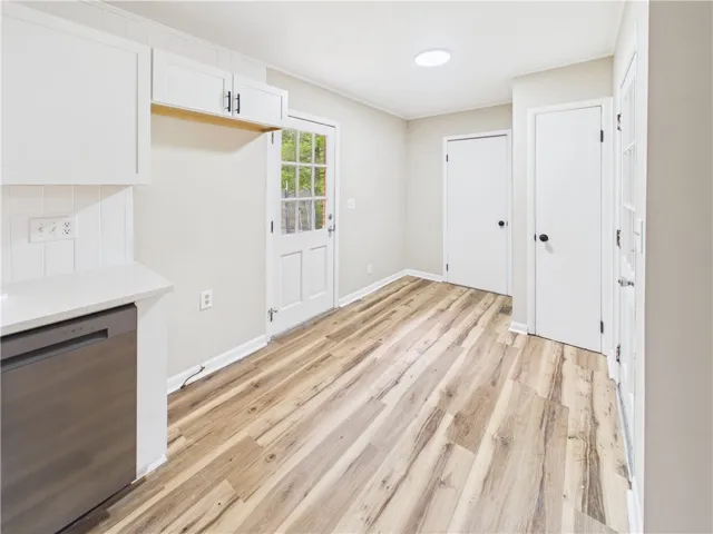 Functional kitchen area with durable wood-look flooring and easy access to the outdoors.