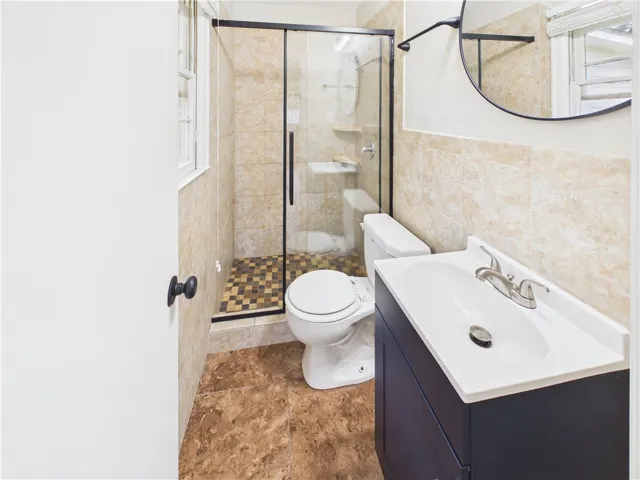 A well-appointed bath features a walk-in shower and contemporary vanity, ideal for daily refreshment.