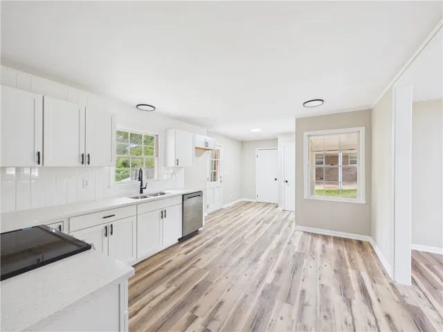 A well-appointed kitchen features sleek countertops and durable plank flooring for effortless daily living.
