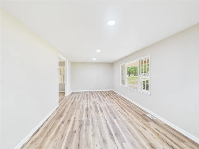 Natural light bathes this flexible interior space with durable wood flooring and streamlined recessed lighting.
