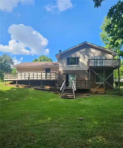A spacious backyard with multiple elevated decks offers ample outdoor living space.