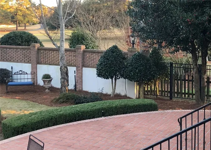 A private outdoor patio with brick pavers and manicured landscaping, perfect for tranquil relaxation.