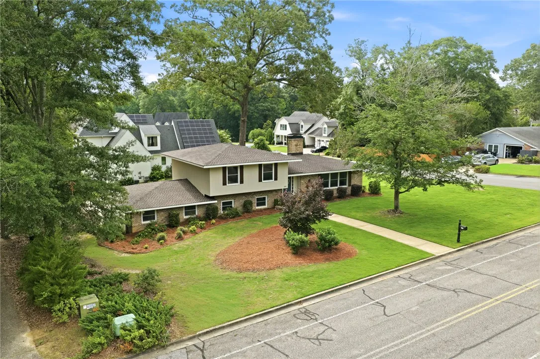 A split-level residence with a well-maintained lawn and mature trees, offering inviting curb appeal.