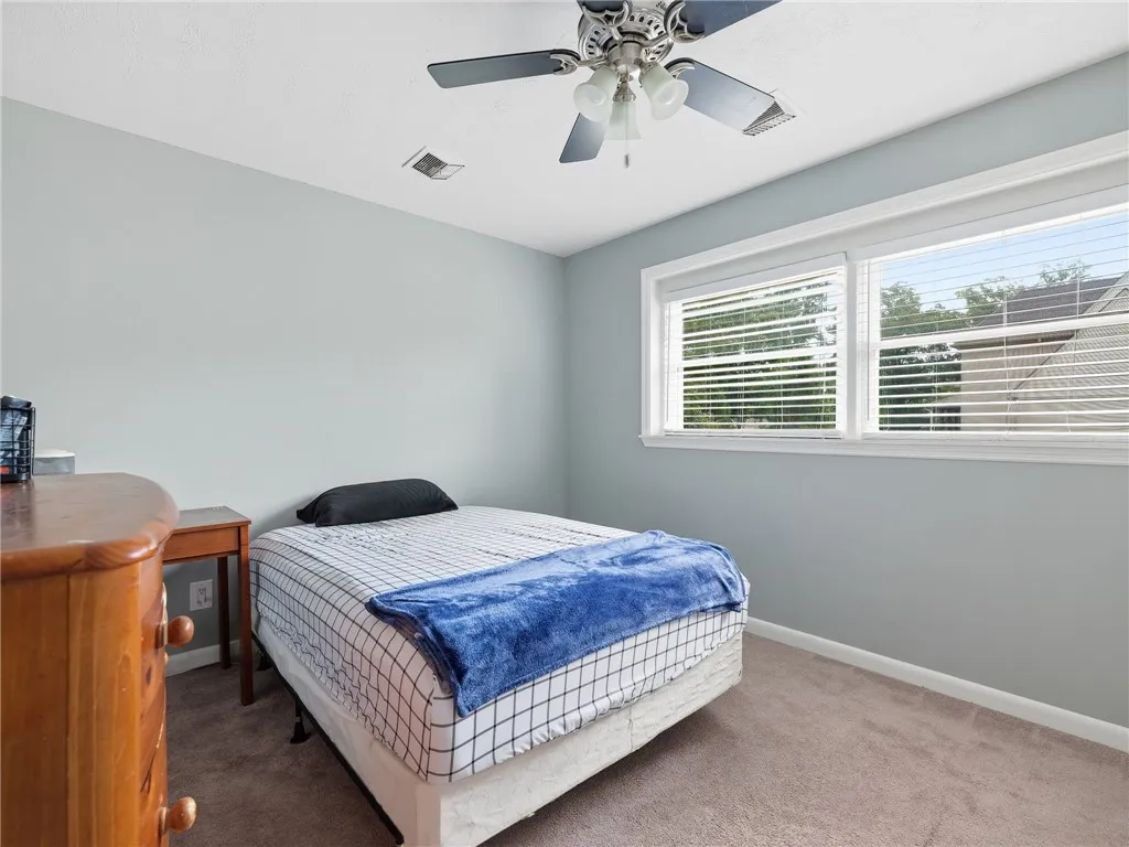 A restful bedroom offers comfort and a well-lit space for unwinding.