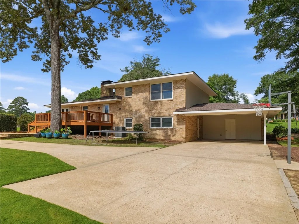 Brick exterior offers classic charm, alongside a spacious deck for outdoor living.
