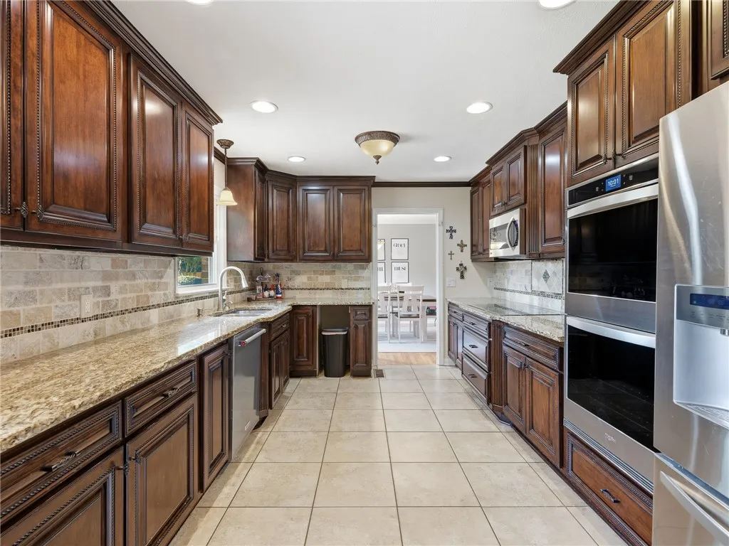 A well-appointed culinary space featuring ample cabinetry and integrated appliances.