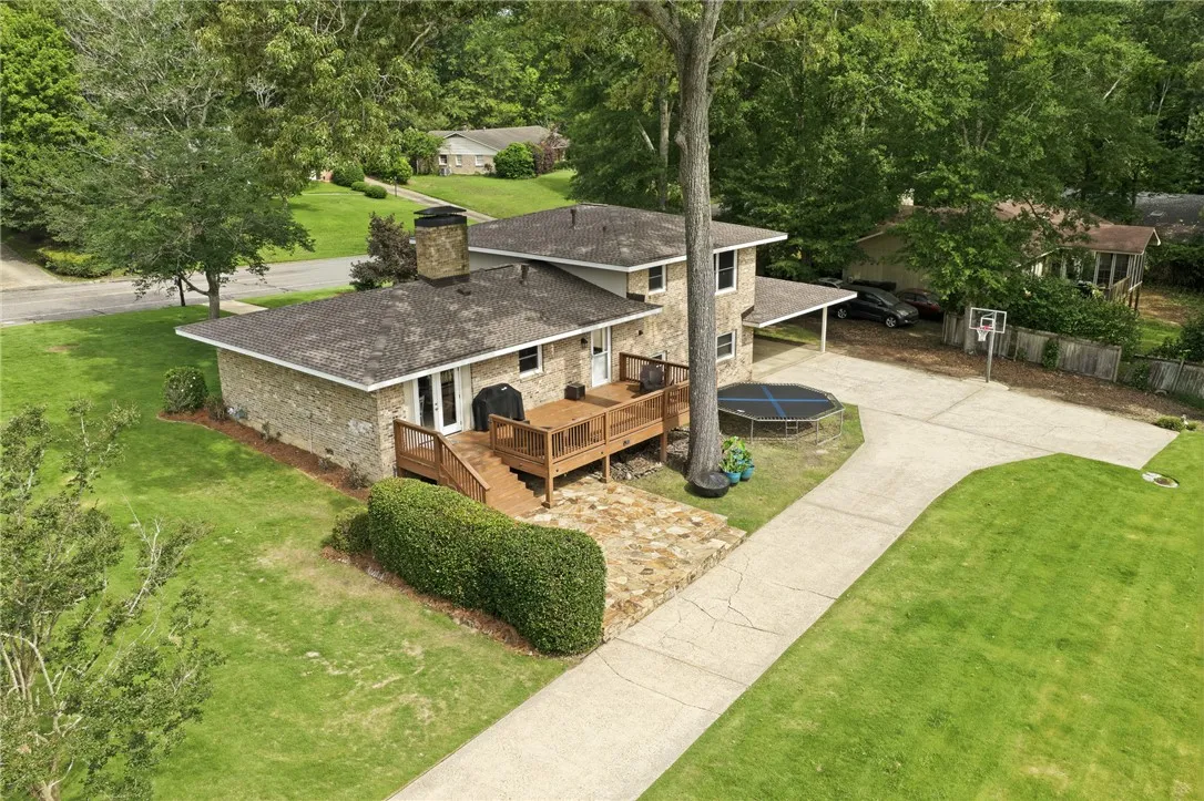 A spacious backyard with an elevated deck offers ample outdoor enjoyment opportunities.