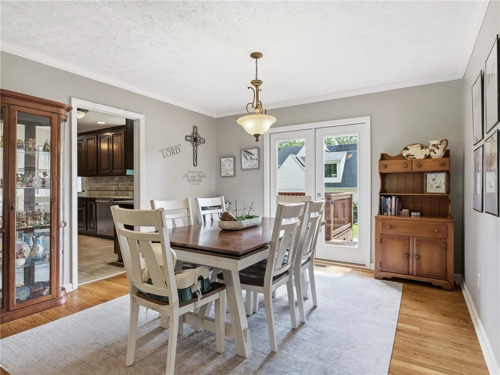 Hardwood floors and a welcoming neutral palette define this comfortable dining area.