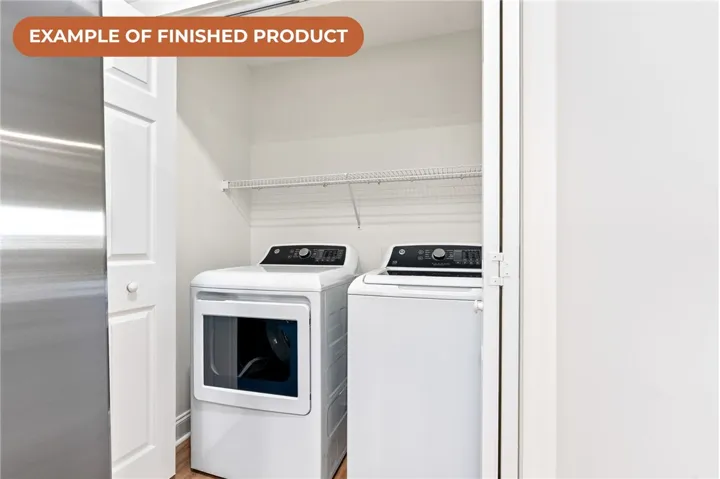 A dedicated laundry space, thoughtfully designed, offers modern appliances and convenient overhead storage.