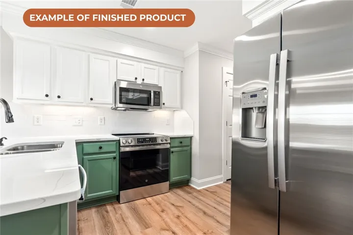 A well-appointed kitchen features stainless steel appliances and classic hardwood flooring.