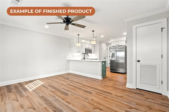 A well-lit, open-concept area combines a functional kitchen with comfortable living space.