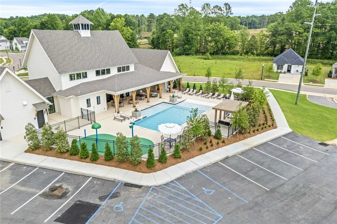 A refreshing pool area, complete with an inviting outdoor kitchen, offers leisure and social enjoyment.