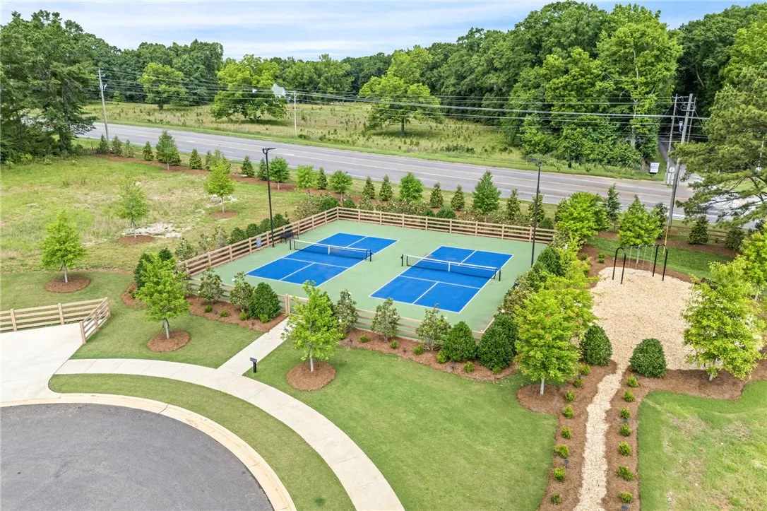 Two vibrant pickleball courts and a nearby playground offer active leisure for all ages.