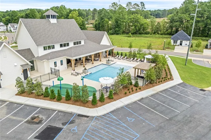 A refreshing pool area, complete with an inviting outdoor kitchen, offers leisure and social enjoyment.