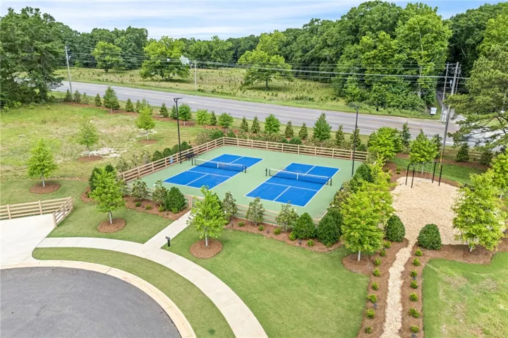 Two vibrant pickleball courts and a nearby playground offer active leisure for all ages.