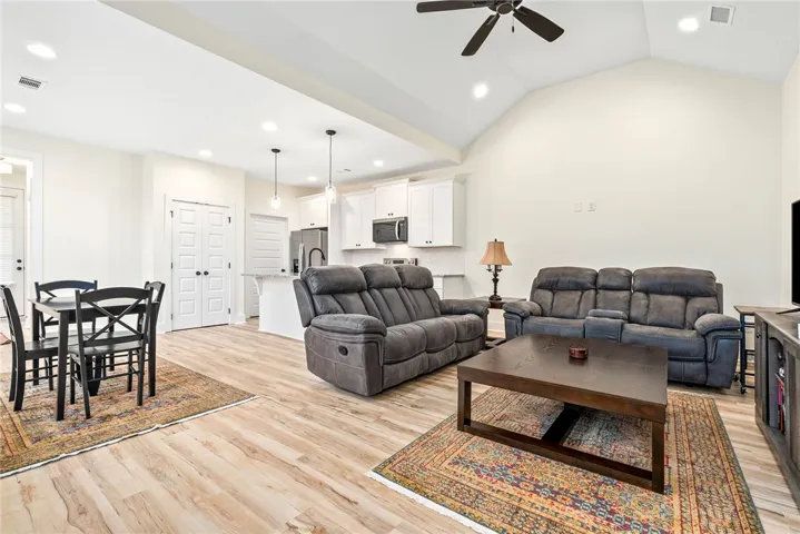 An airy living area with vaulted ceilings and ample space for dining and entertaining.