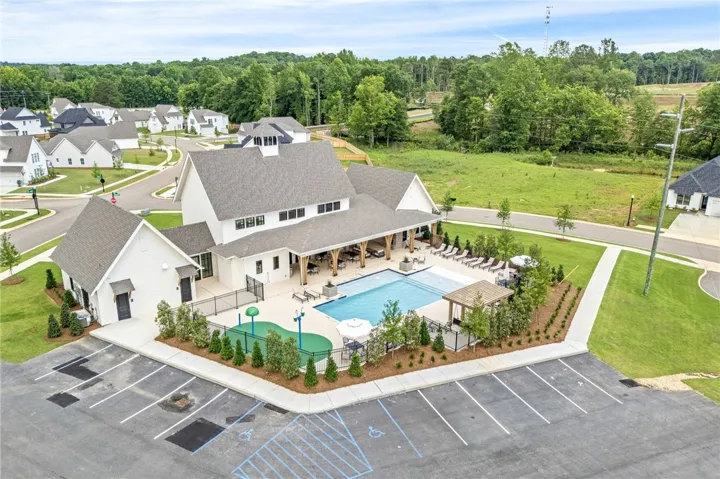 An aerial perspective reveals a vibrant community hub with a crystal-clear swimming pool and ample leisure space.