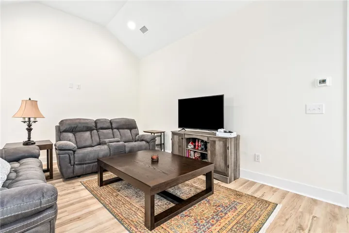 Generous ceiling height enhances this well-appointed room, offering an inviting space for relaxation.
