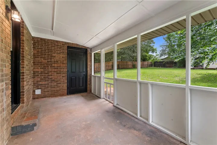 A screened porch offers a private retreat with views of the verdant yard. Access door to laundry room area.
