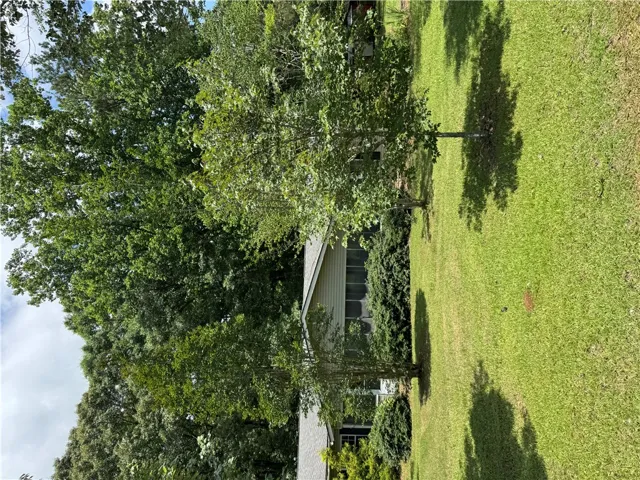 A verdant lawn surrounds this home, offering a peaceful, private yard.