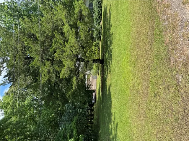 A verdant lot with mature trees offers a private, serene natural setting.
