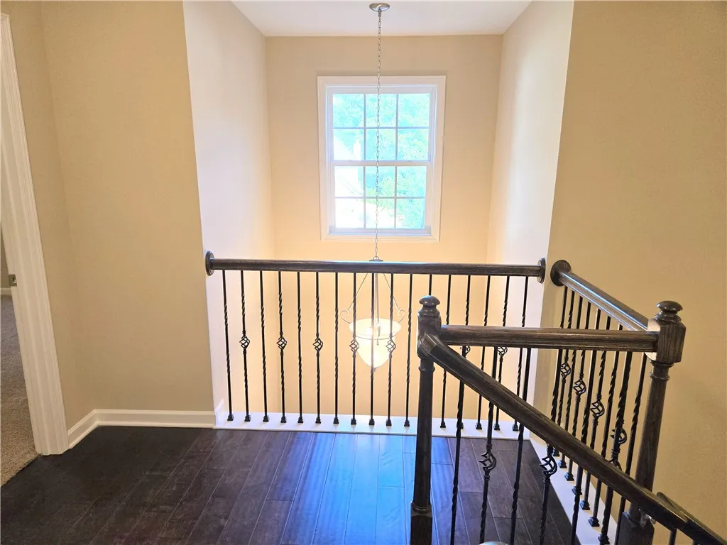 Ornate wrought iron balusters line the staircase, adding a touch of classic elegance to this home's entrance.